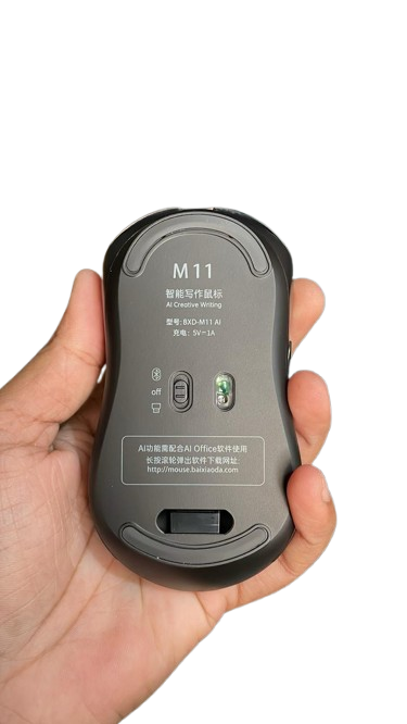 Hand holding a black computer mouse labeled 'M11' on a white background